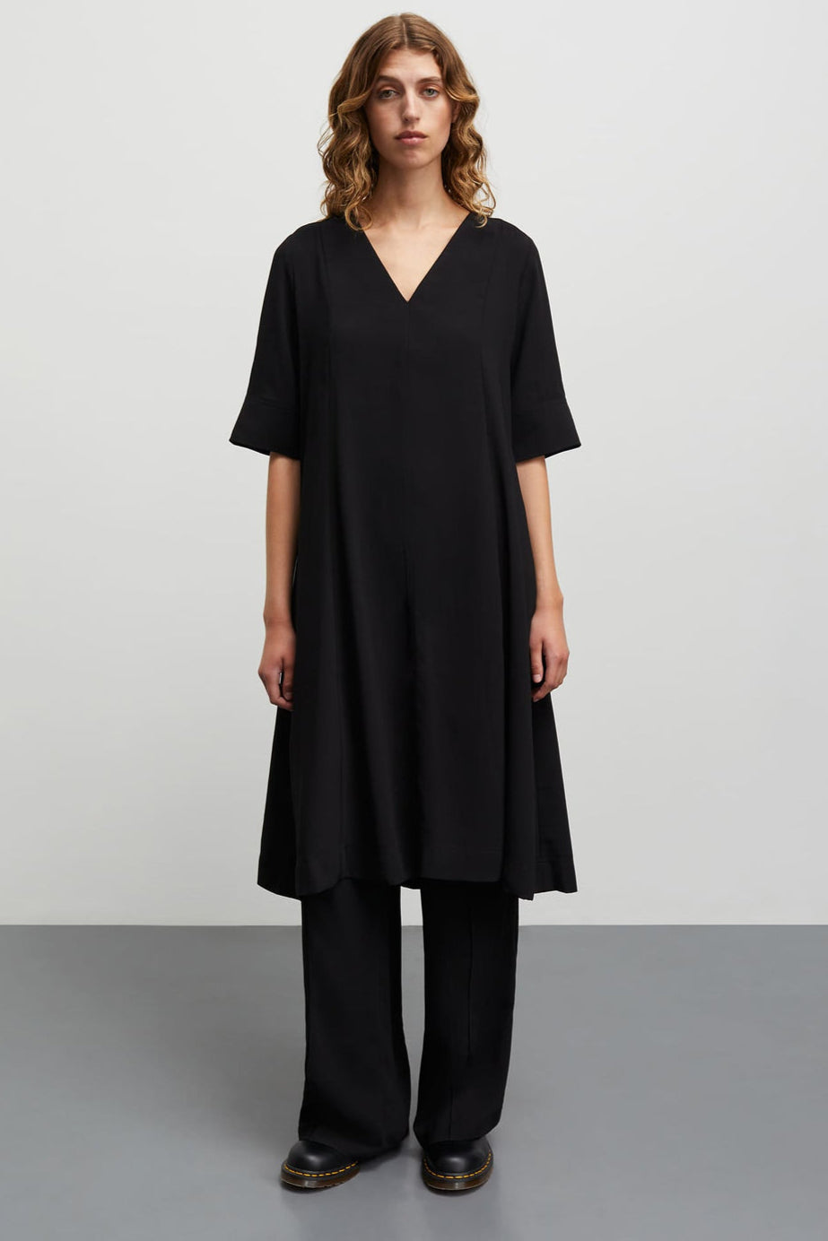 Mads Nørgaard Light Crepe Margot Dress i black. Løs kjole i genanvendt polyester med V-udskæring og korte ærmer.