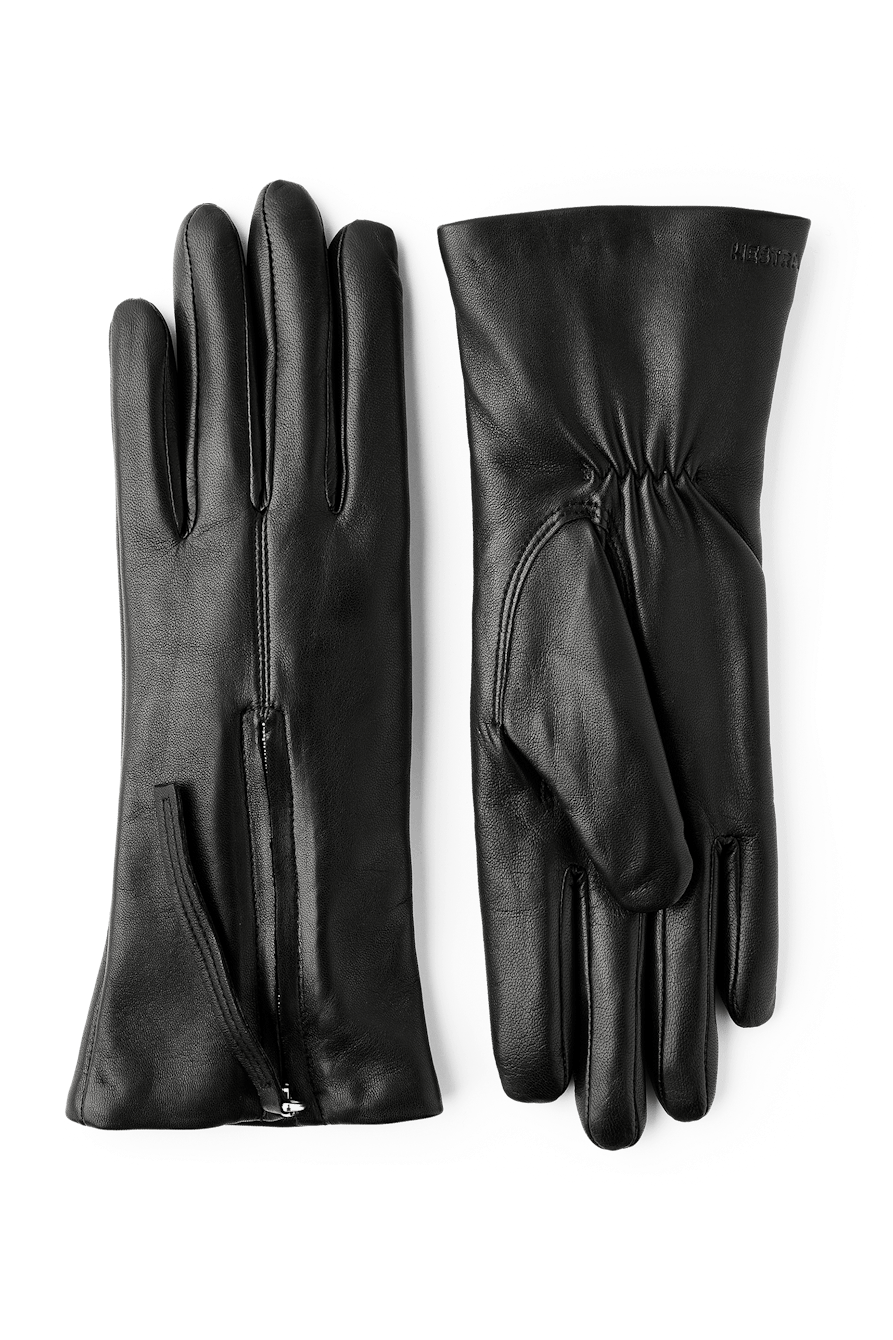 Hestra Vera Læderhandsker i sort – elegante handsker i italiensk lamme-nappa med blødt uld/polyamid-for og dekorativ lynlåsdetalje.
