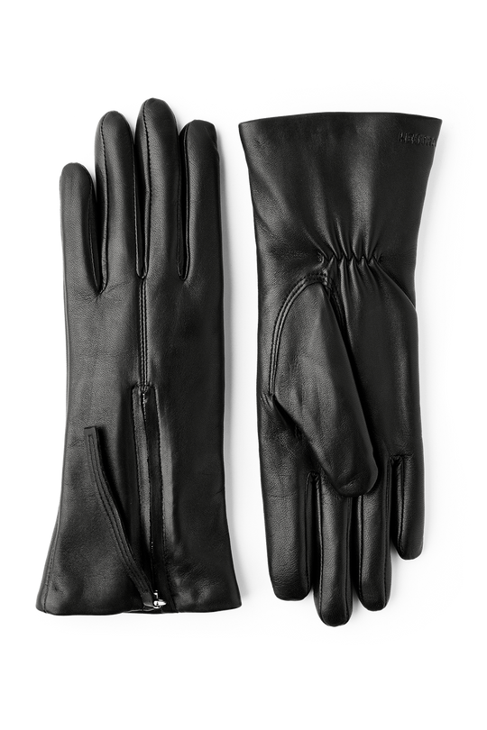 Hestra Vera Læderhandsker i sort – elegante handsker i italiensk lamme-nappa med blødt uld/polyamid-for og dekorativ lynlåsdetalje.
