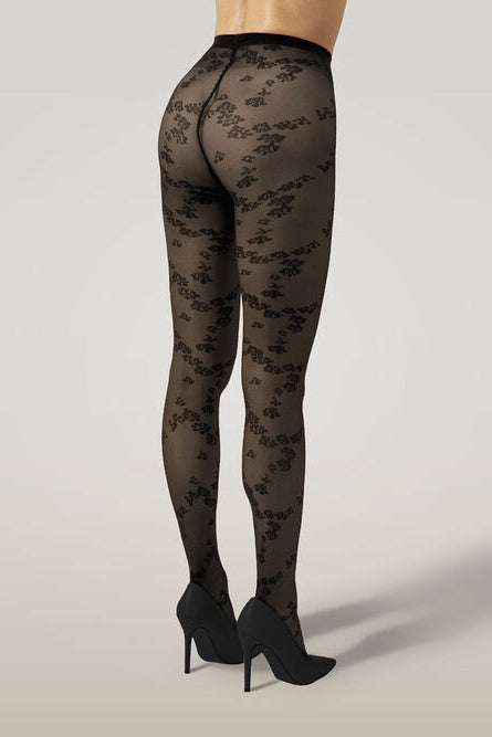 Wolford Floret Tights i sort – strømpebukser med blomsterprint, kombination af transparente og uigennemsigtige sektioner og mat finish.
