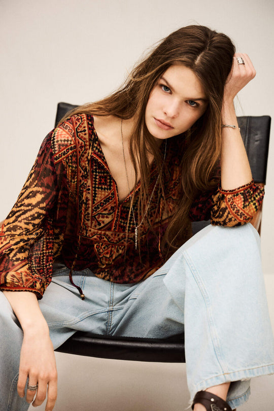 ba&sh Odetta Blouse – Rouge. Bluse med detaljeret print, åben V-hals med bindedetalje, puffede skuldersømme og voluminøse 3/4-ærmer i 100% viscose.
