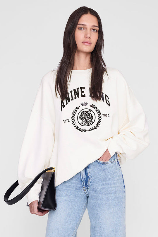 Anine Bing Miles Collegiate Sweatshirt i cream – oversized sweatshirt i bomuldsfleece med ribkanter og collegiate ANINE BING-logo foran.
