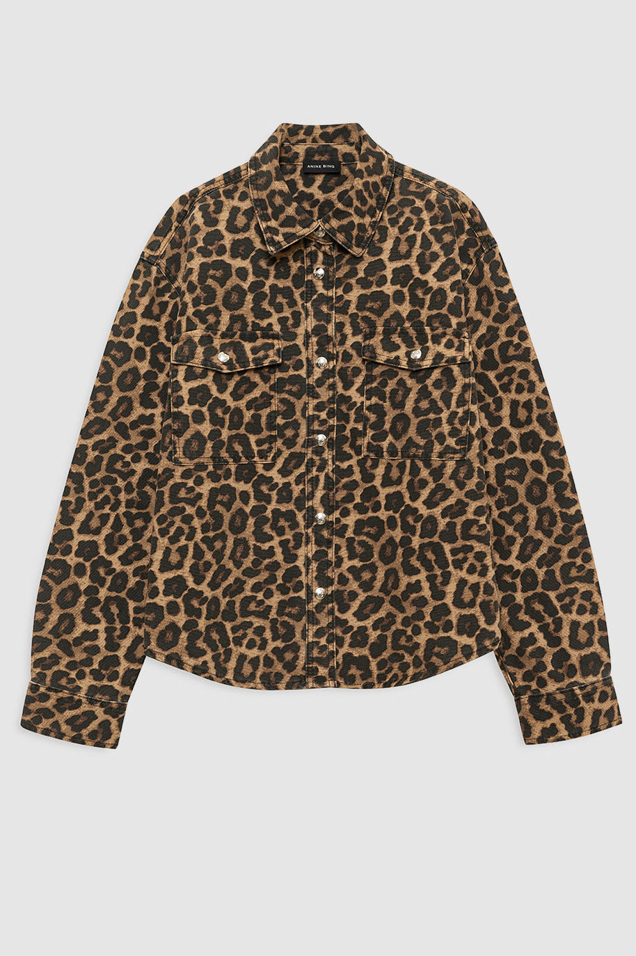 Anine Bing Paxton Shirt i Black & Brown Leopard – skjortejakke i rigid bomuldsdenim med vintage leopardprint, brystlommer og knaplukning.
