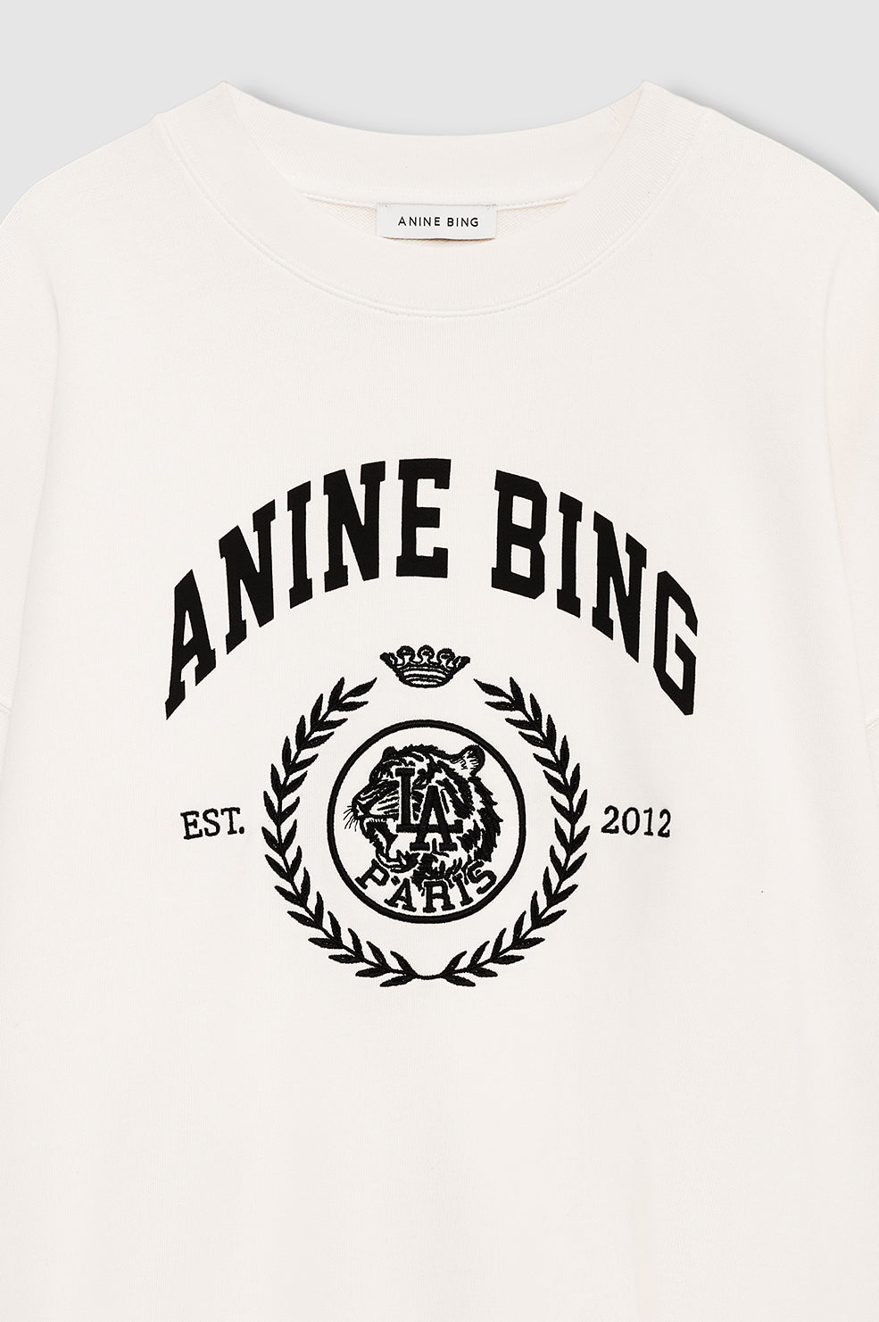 Anine Bing Miles Collegiate Sweatshirt i cream – oversized sweatshirt i bomuldsfleece med ribkanter og collegiate ANINE BING-logo foran.
