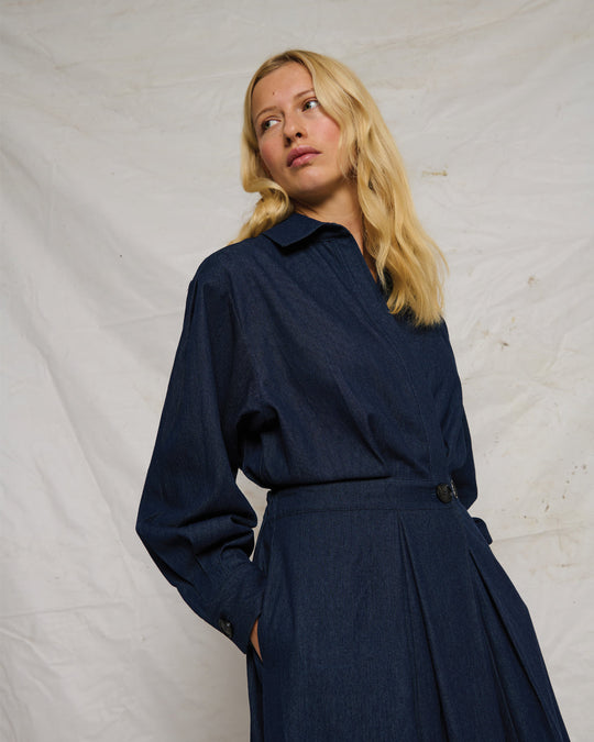 La Rouge Charlotte Dress i dark denim – langærmet kjole i let denim med skjortekrave, V-hals, markeret talje og draperet front.
