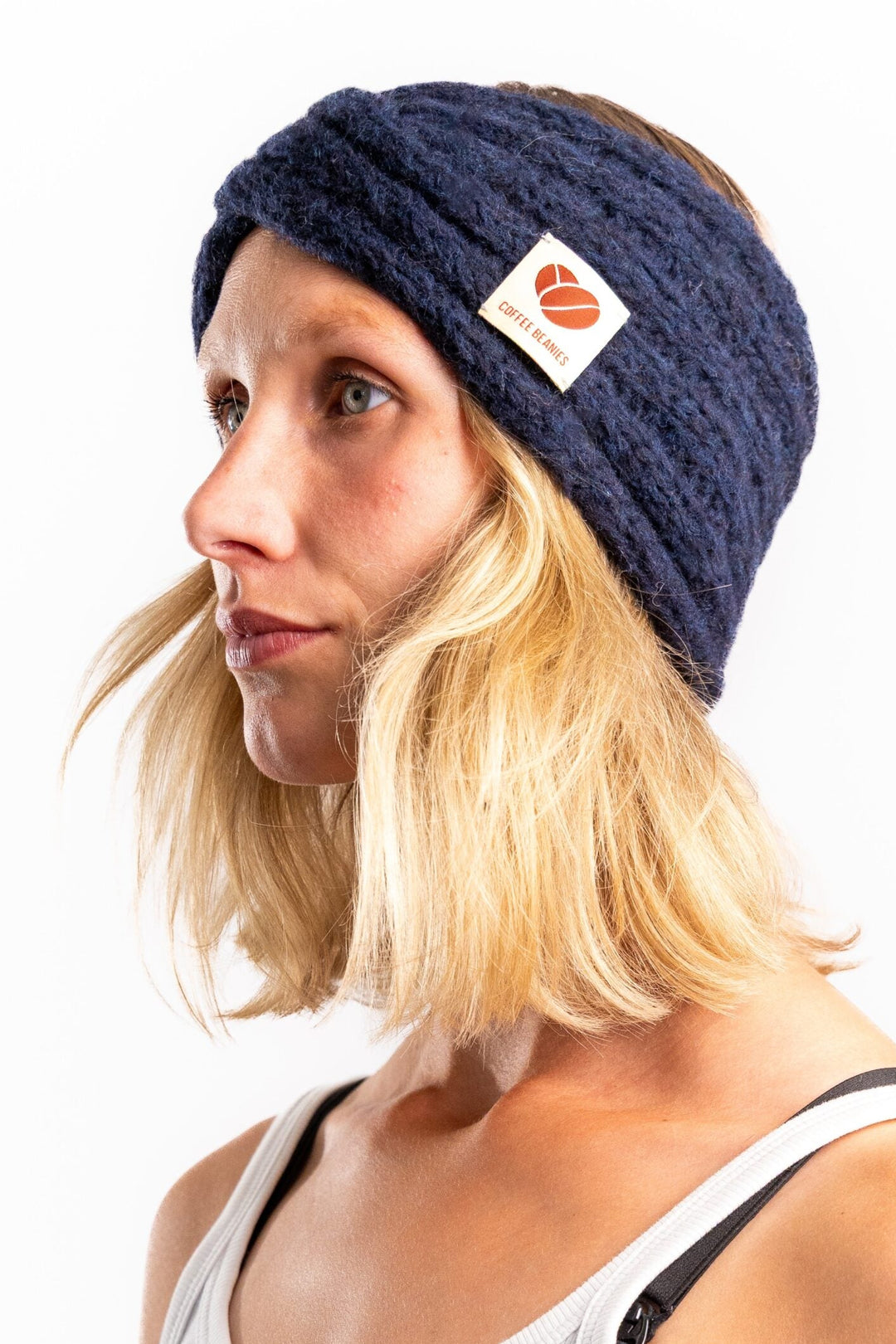 Coffee Beanies pandebånd i navy, håndstrikket af en uld- og alpaka-blanding med snoet detalje foran.

